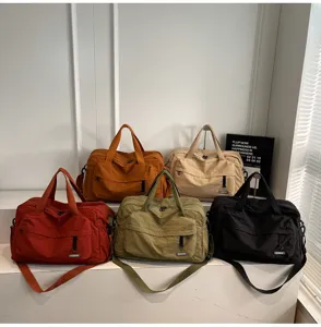 Multi-color large capacity travel duffel gym bags neatly displayed on white steps.