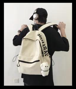 Korean style minimalist solid color canvas school backpack for women and students daily use.