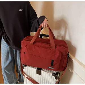 Large capacity travel duffel bag for fitness and sports, durable red weekend overnight bag.