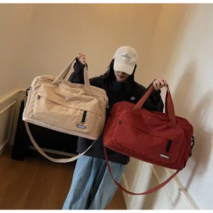 Large capacity travel duffel bag in beige and red, showing detailed view and features.