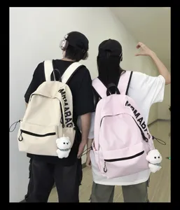 Korean style minimalist canvas backpack for students, casual large capacity school bag with bear pendant.