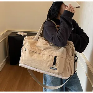 Large capacity travel duffel bag for fitness sports and gym, khaki waterproof fabric design.