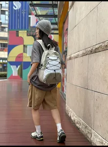 Dettaglio zaino coulisse esterno, zaino trekking casual con cordino elastico, borsa scolaresca.