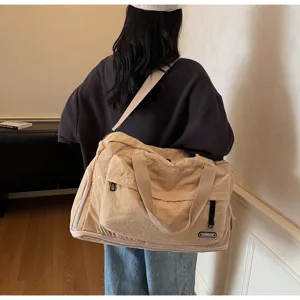 Large capacity travel duffel bag for gym and sports, waterproof canvas fitness shoulder bag.