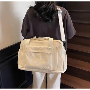 Detailed view of large capacity cream travel gym bag with multi pockets and shoulder strap.