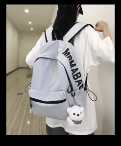 Casual minimalist student schoolbag light grey backpack with cute bear pendant for daily use.