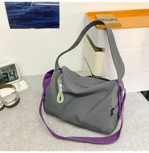 Grey gym shoulder bag detail view, stylish multi-functional travel duffel with purple straps.