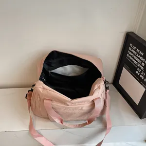 Stylish pink gym bag with large capacity, durable fabric, shoulder strap for travel and sports.