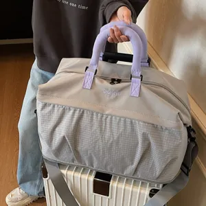 Large capacity travel duffel bag in grey with purple handles, perfect for short trips and gym.