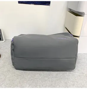 Grey casual travel gym duffel bag with purple embroidered logo, durable large capacity.