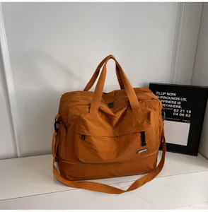 Large capacity travel gym bag in brown nylon, waterproof sports tote with wet dry separation for fitness.
