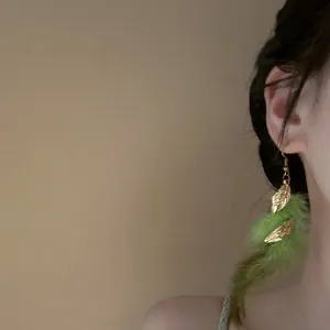 Bohemian green feather tassel earrings with vintage gold leaf detail for women fashion style.