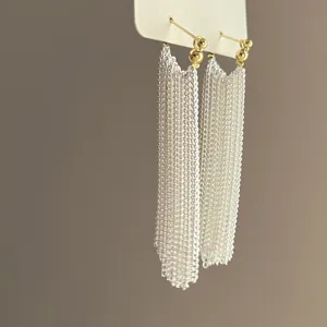 Silver bead tassel earrings with gold-tone ball studs, elegant bohemian fringe jewelry.