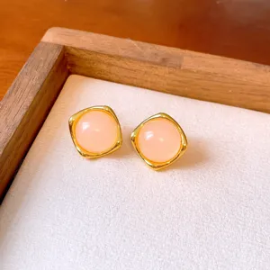 Elegant square gold-trimmed pink gemstone stud earrings for stylish and chic daily wear.