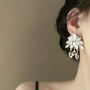 Detailed close-up view of luxury crystal floral drop earrings, elegant resin fashion jewelry.