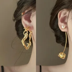 Gold-plated statement earrings featuring abstract irregular shapes and pearl flower drops.