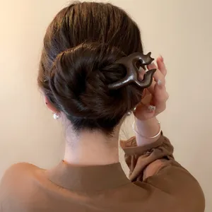 Close-up detail of a wooden hair fork, retro Chinese style hair accessory for women.