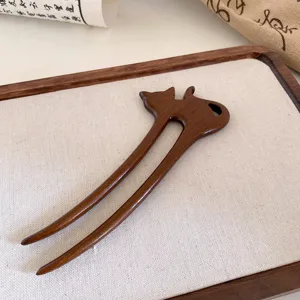 Minimalist wooden hair fork with cute animal silhouette design, elegant retro hair accessory.