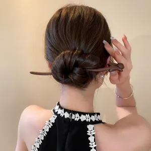 Detailed view of Chinese style wooden hair stick with elegant fox design for vintage updos.