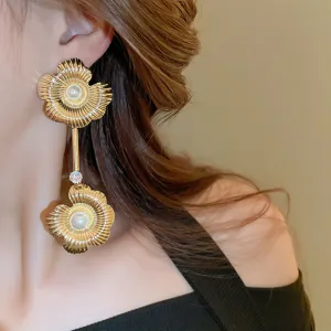 Exquisite gold flower pearl tassel dangling earrings detail shot, elegant fashion ear jewelry.