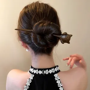 Wooden hair stick detail view, featuring a cute animal design for minimalist retro hairstyles.
