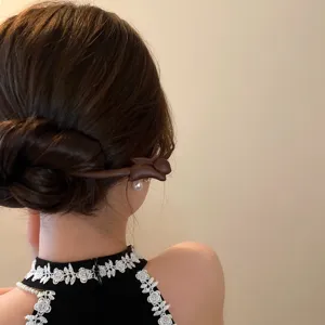 Wooden hair stick detail view, minimalist Chinese style animal hairpin for elegant retro updo hairstyles.