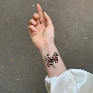 Waterproof temporary tattoo sticker with butterfly and red roses design for wrist decor.