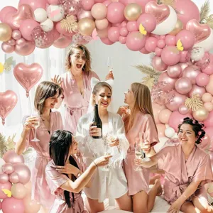 Pink gold balloon arch kit detail for birthday party decoration, stunning backdrop setup.