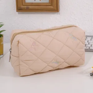 Quilted cosmetic bag with cute bow embroidery, spacious portable makeup pouch for daily travel.