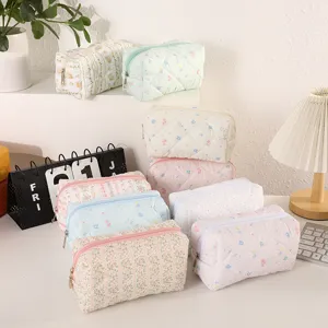 Primer plano neceser acolchado, suave estuche floral con cremallera y diseño amplio.