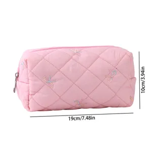 Pink quilted makeup bag with cute embroidered bows, compact and portable storage pouch.