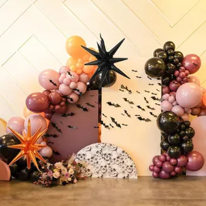 Halloween party balloon arch detail showcasing dark themed explosion star balloons and bats decor.