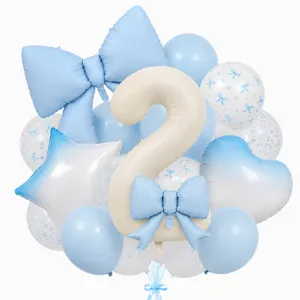 Closeup detailed view of cream bow number 2 balloon set for children birthday party decor.