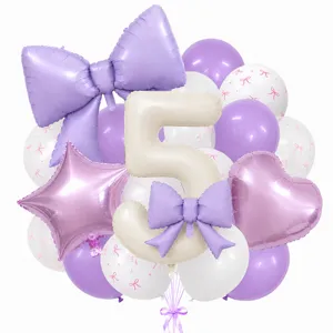 Detail view of the cream bow and number 5 balloon set, featuring pastel party decorations.