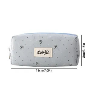 Detailed view of grey bow pattern pencil case with Colorful brand label and size info.