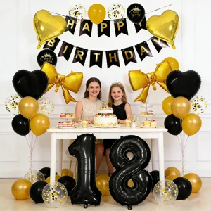 Black and gold birthday party balloon decoration set with happy birthday banner and foil heart bows.