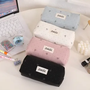 Large capacity canvas pencil pouch with cute bow embroidery and stylish label for students.