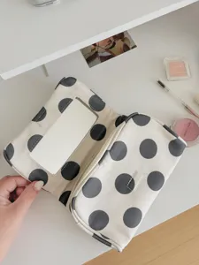 Detail shot of the polka dot cosmetic bag interior showing the built-in mirror and fabric.