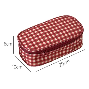 Red and white gingham pencil case detail, rectangular storage pouch with smooth zipper closure.