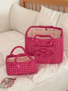 Detailed view of the pink gingham quilted storage basket with sweet bows and floral interior.
