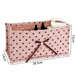 Pink quilted storage box with brown polka dots and cute bow detail for desk and cosmetic organization.