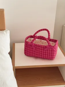French vintage pink check quilted storage basket detail view showing sweet bow handles and fabric.