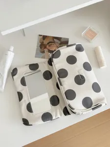 Polka dot canvas makeup bag with mirror, portable travel cosmetic organizer detail.