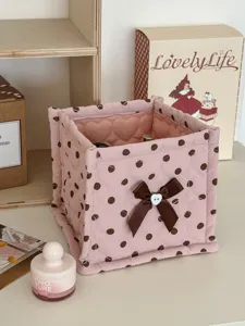 Pink polka dot quilted storage basket with cute bow detail, perfect for desk and dorm organization.