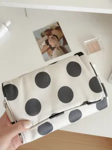 Large polka dot canvas makeup bag, portable travel storage pouch with stylish aesthetic design.