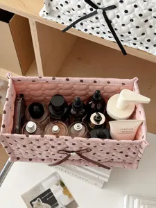 Pink polka dot quilted storage basket detail view, perfect for desktop cosmetic organization.
