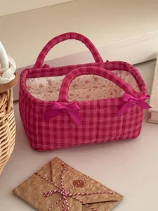 Pink quilted storage basket detail view with cute bows and floral lining for home organization