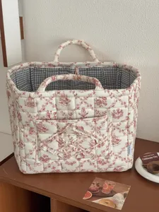 French vintage quilted storage basket with red floral toile print, double handles, front pocket.