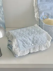 Blue quilted fabric storage basket with white lace trim, cute rectangular organizer box for bedroom.