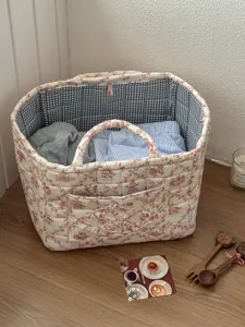French vintage quilted storage basket featuring floral print and blue plaid lining.